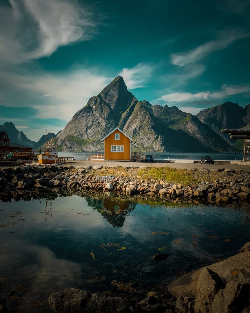 Photo by Tobias Bjørkli Brown Wooden House Near Mountain